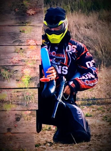 Jugador de paintball deportivo recargando marcadora en campo de Sax Alicante